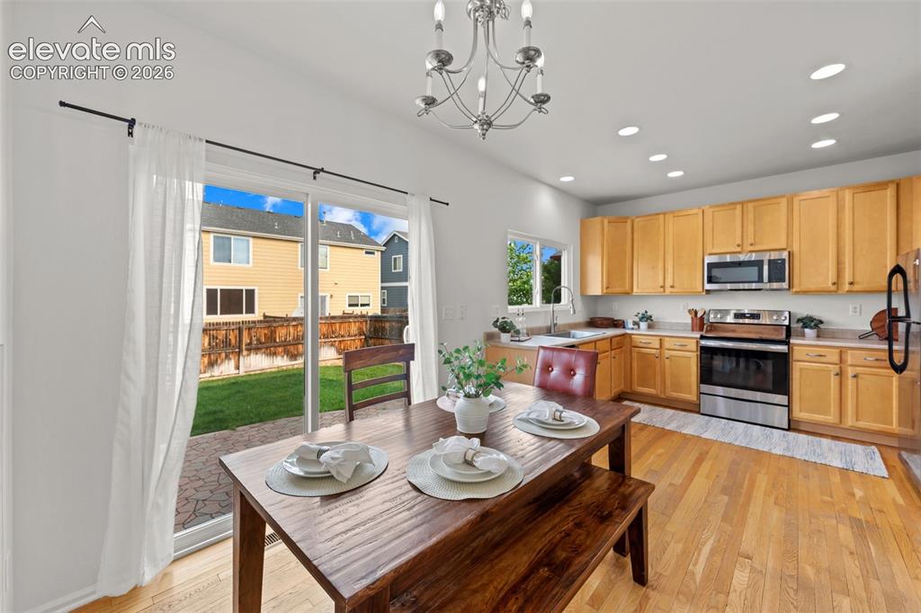 Image 6 of 31: Dining area walks out to level, landscaped yard