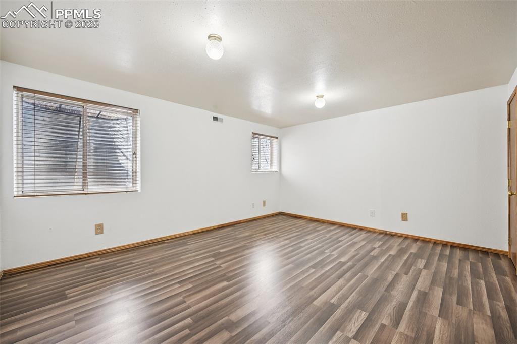 Image 14 of 28: Empty room with wood finished floors