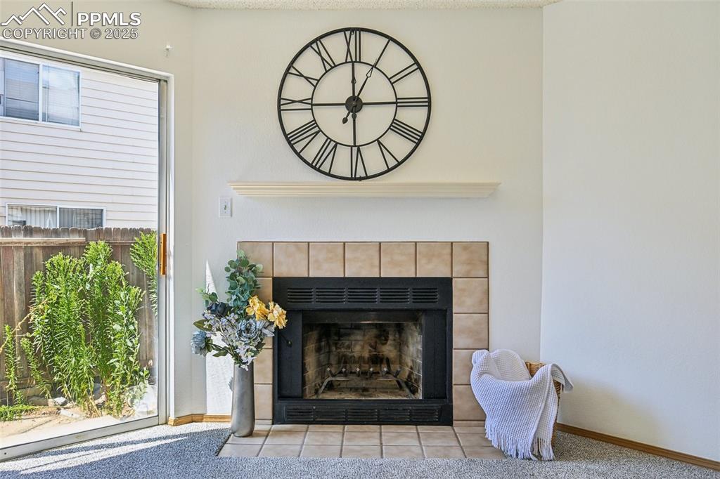 Image 6 of 28: Detailed view of a tiled fireplace and carpet flooring