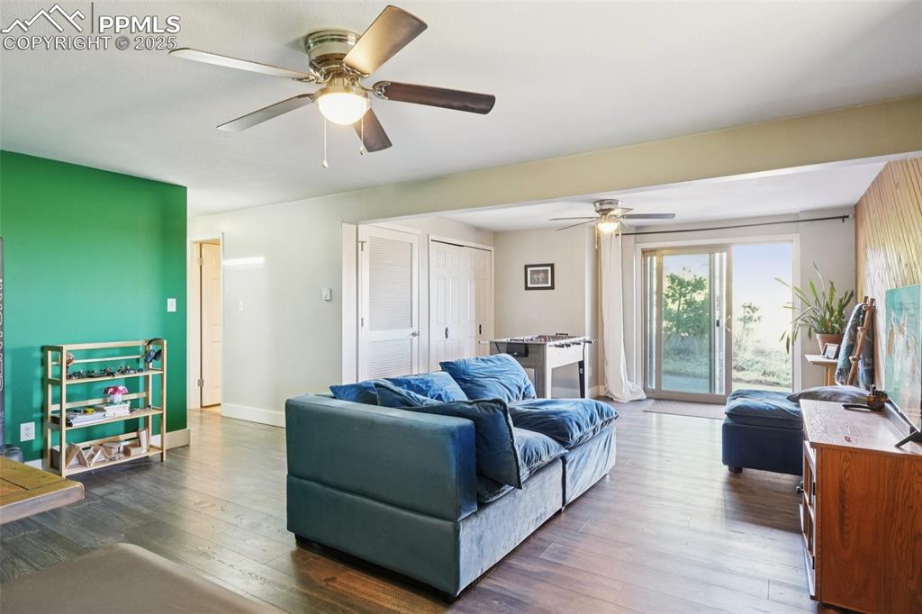 Image 26 of 38: Family room with walk out to covered back patio, wood burning stove and lau