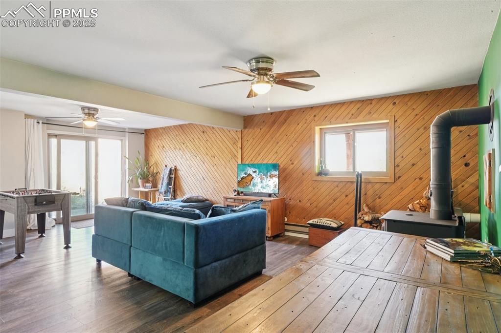 Image 27 of 38: Family room with walk out to covered back patio, wood burning stove and lau
