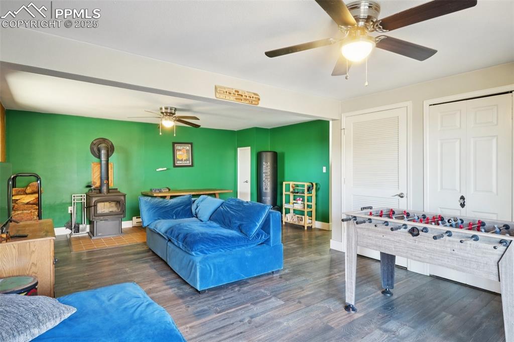Image 29 of 38: Family room with laundry, wood burning stove and walk out to back patio