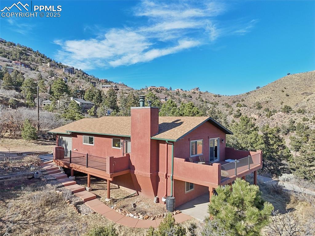 Image 32 of 38: View of the home surrounded by mountains