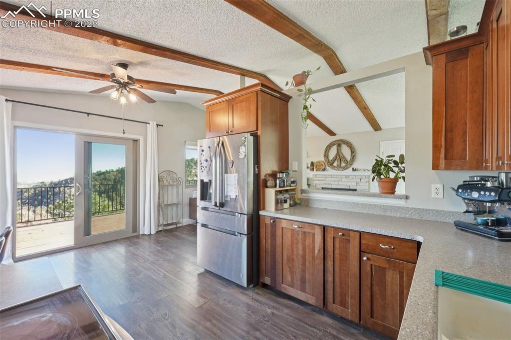 Image 9 of 38: Kitchen with Corian countertops, dual sink, stainless steel appliances and 