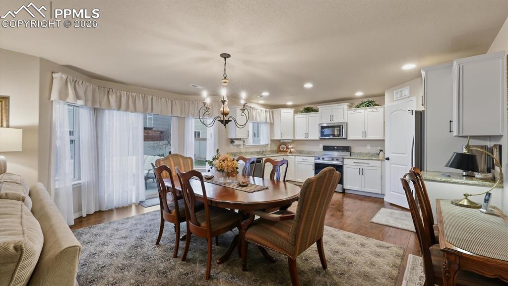 Image 13 of 50: Kitchen/Dining Area with slider to the backyard patio.