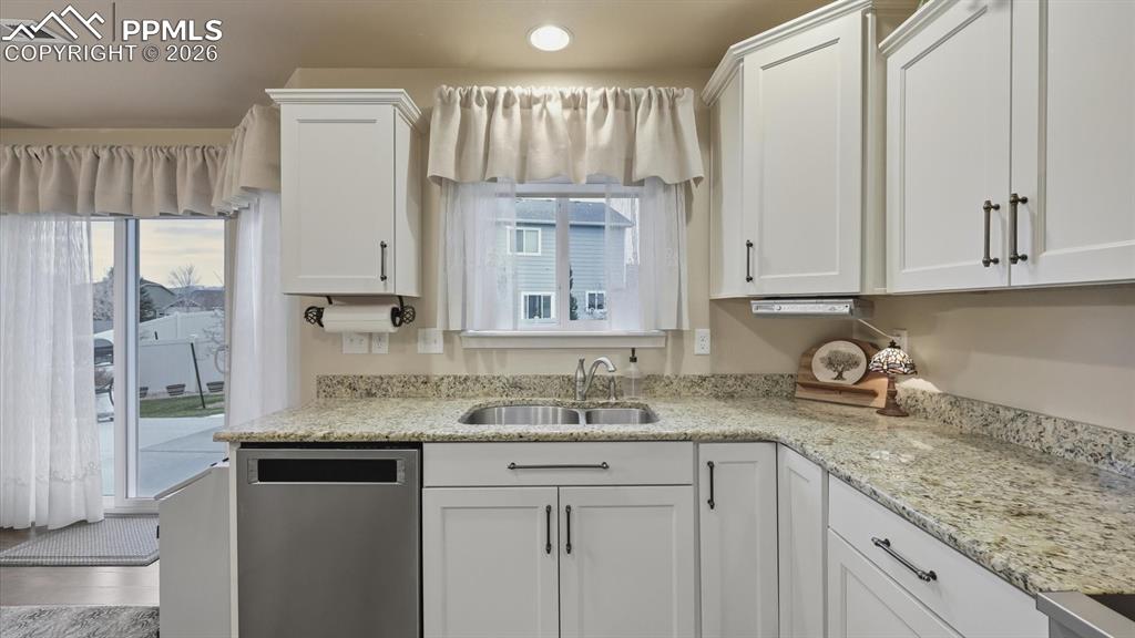 Image 19 of 50: Beautiful granite countertops and a dual stainless steel sink.
