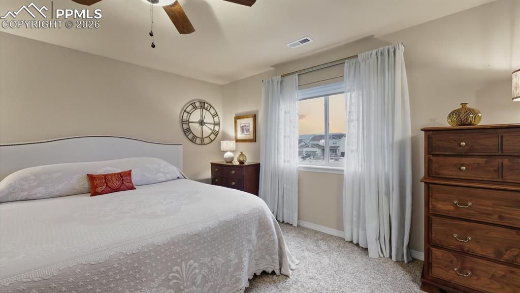 Image 24 of 50: The upper level Primary Bedroom offers beautiful mountain views from the wi