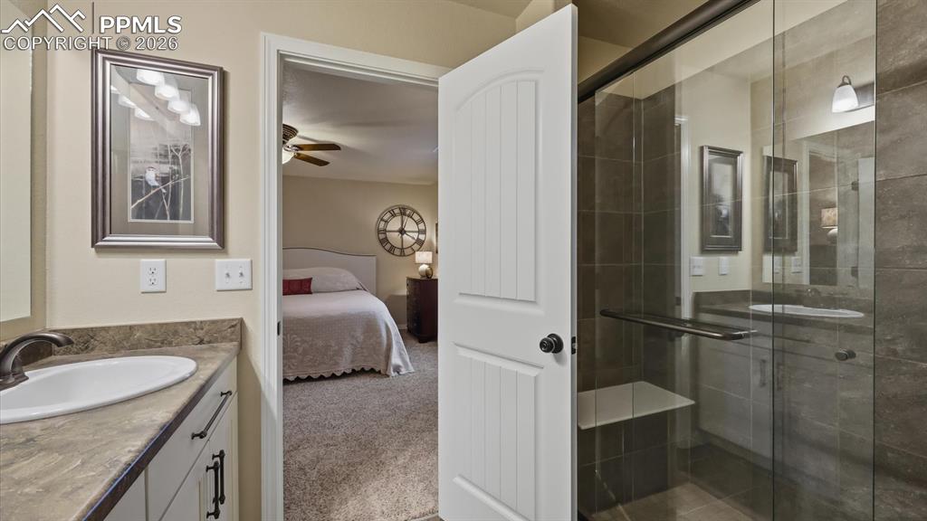 Image 28 of 50: Enclosed tiled shower with built-in seat in the Primary Bathroom.