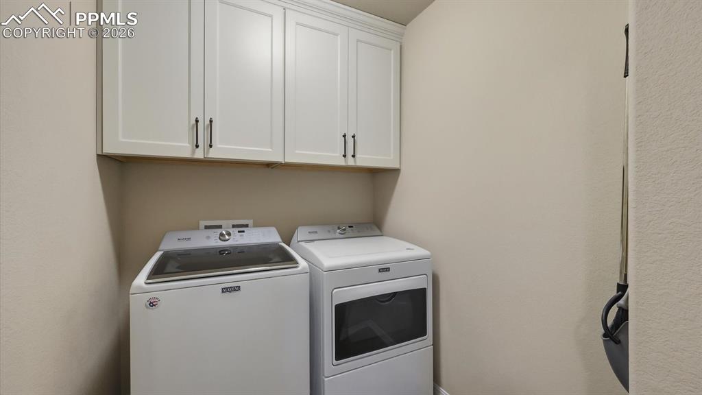 Image 30 of 50: Upper Level Laundry Room with upper cabinets to the ceiling.