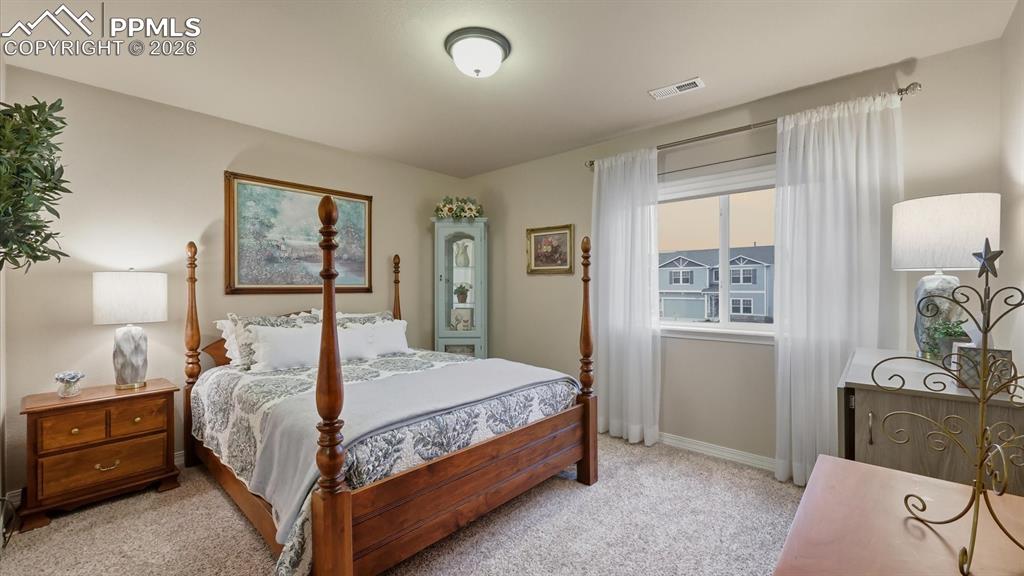 Image 33 of 50: Upper Level Bedroom #3 with neutral carpet.