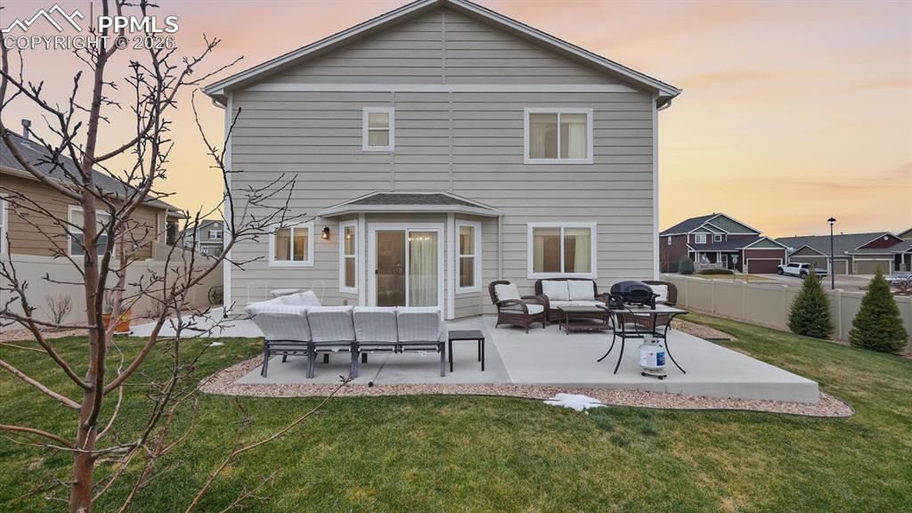 Image 42 of 50: Rear view of home and backyard.