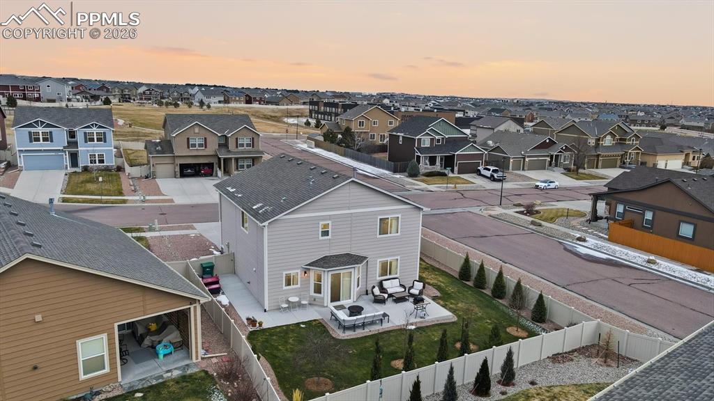 Image 44 of 50: Aerial rear view of home and fenced backyard.