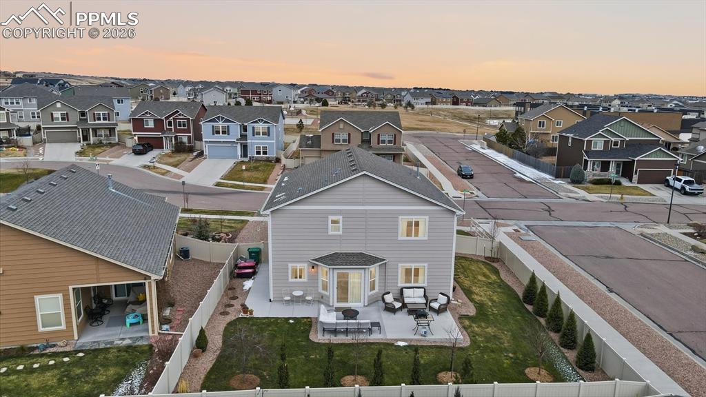 Image 45 of 50: Large concrete patio with walkway on the side yard.