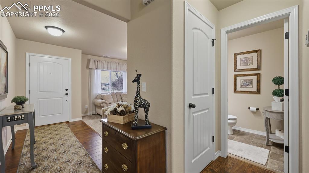 Image 7 of 50: Front Entry with gleaming hardwood floors.