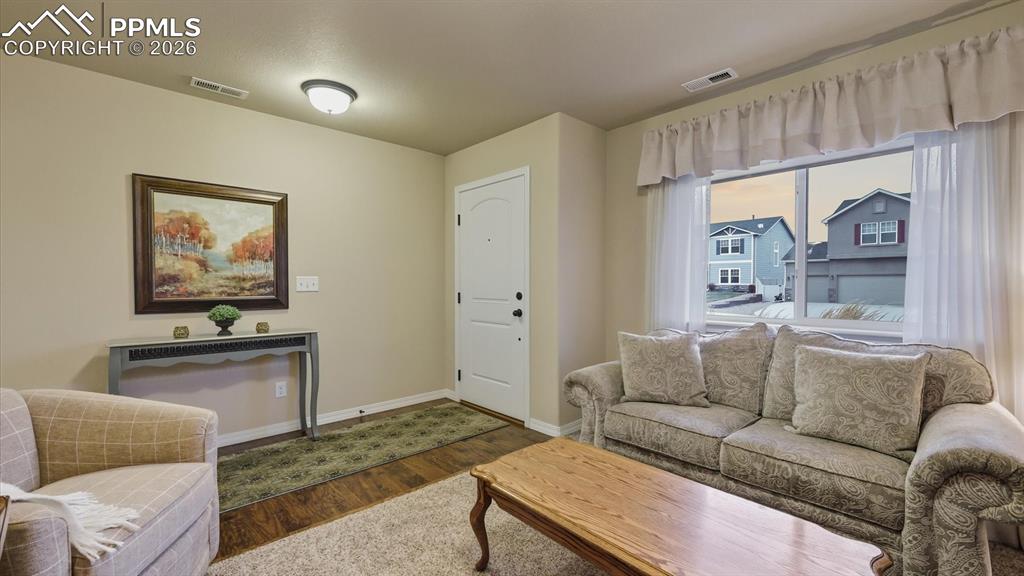 Image 8 of 50: Formal Living Room with large window and front yard views.