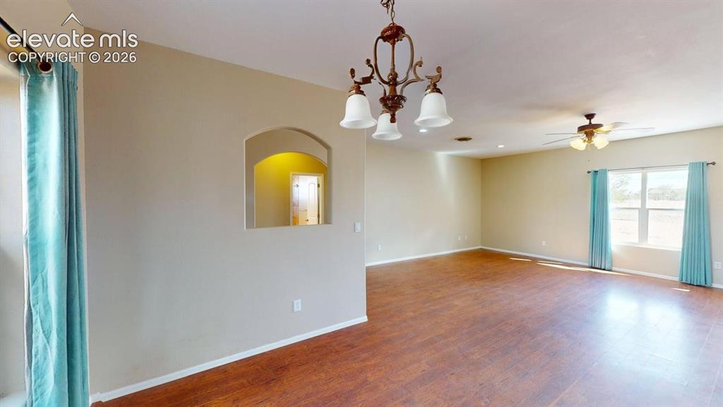 Image 19 of 50: Expansive interior featuring wood-finish flooring, an arched wall niche, an