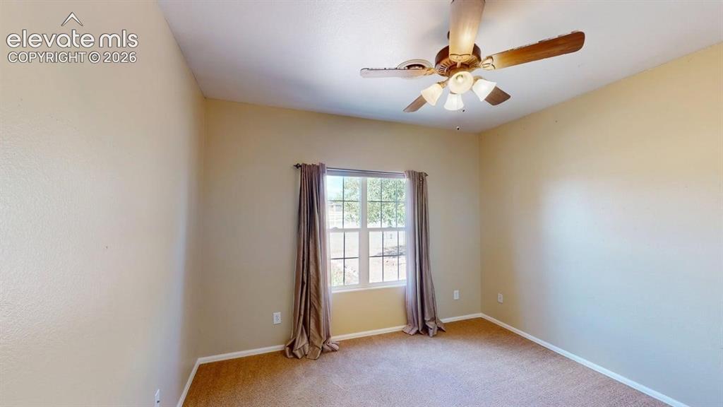 Image 22 of 50: Ceiling fan with integrated lighting, carpeted flooring, and a window with 