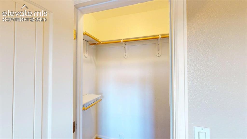 Image 23 of 50: Built-in closet shelving with a hanging rod