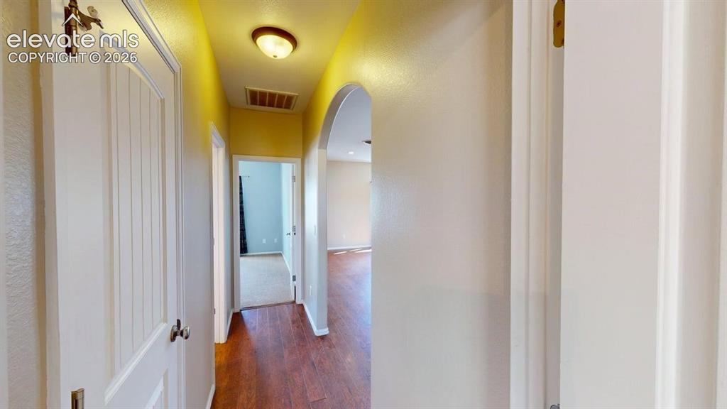 Image 25 of 50: Wood-finish flooring throughout the hallway