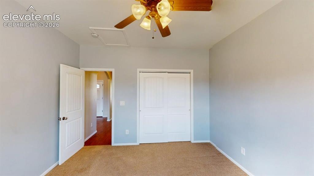 Image 27 of 50: Ceiling fan with light kit, neutral wall paint, carpet flooring, and white