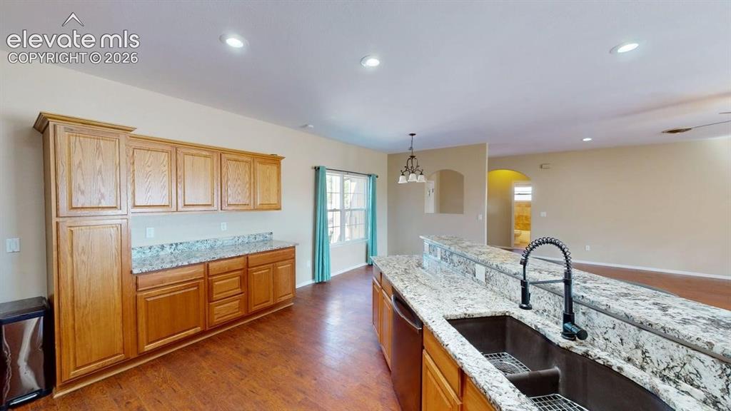 Image 9 of 50: Expansive island with a double basin sink and a contemporary faucet, comple