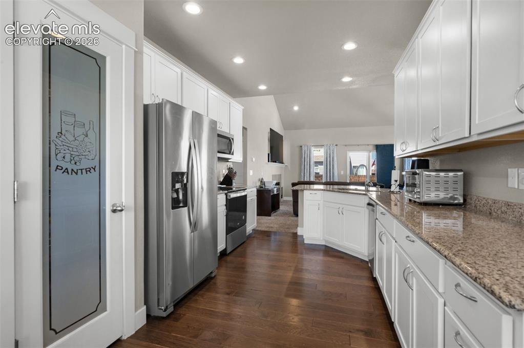 Image 16 of 40: Notice the sigh decor in the pantry door.