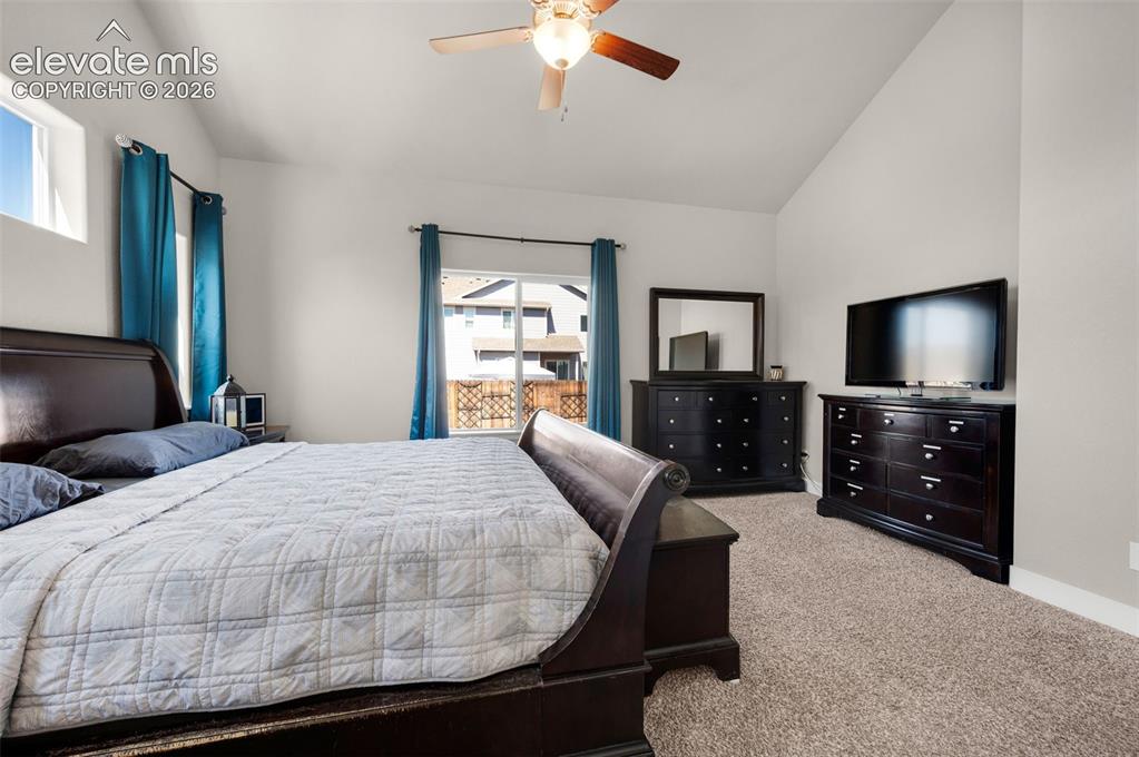 Image 23 of 40: Primary bedroom is carpeted with lots of windows