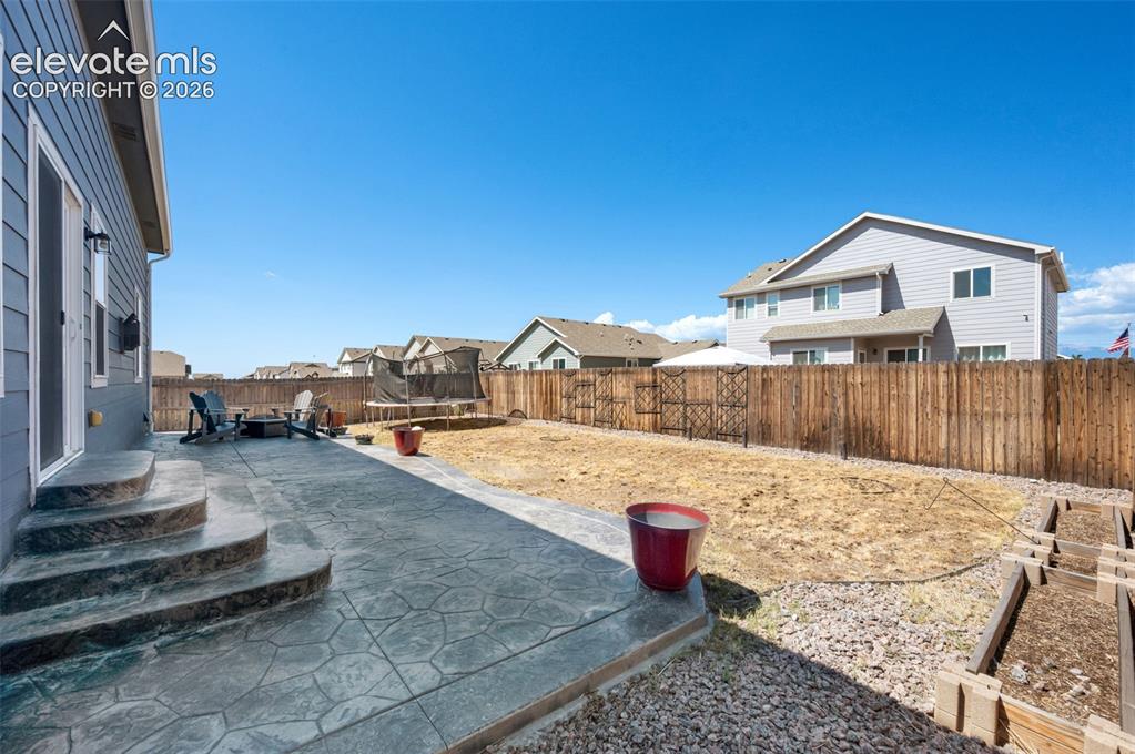 Image 36 of 40: Enjoy a barbecue on the patio in your fenced back yard