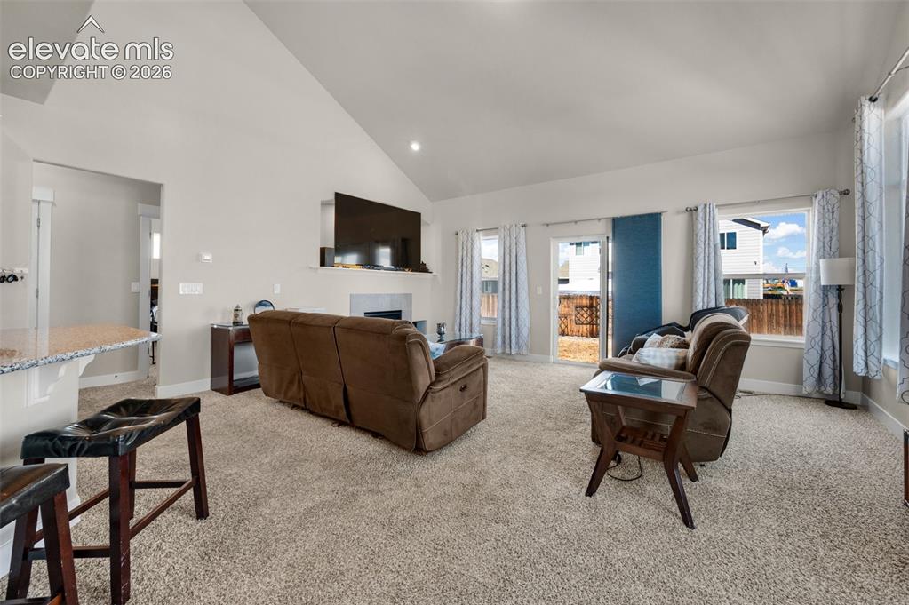 Image 5 of 40: Living room enjoys a vaulted ceiling