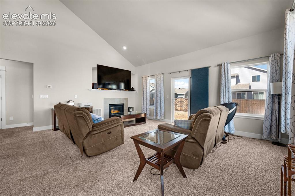 Image 6 of 40: Living room has patio door that leads to patio in fenced back yard