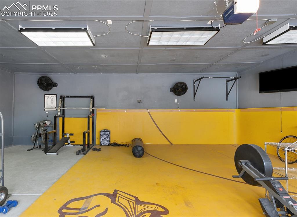 Image 25 of 29: The garage has been used as a fitness room.