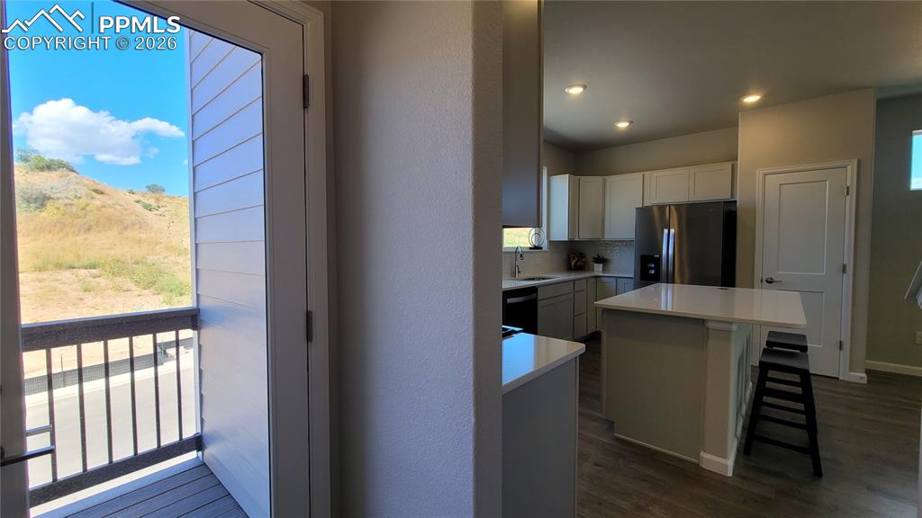 Image 15 of 28: Kitchen with Quartz countertop, pantry, island providing additional seating