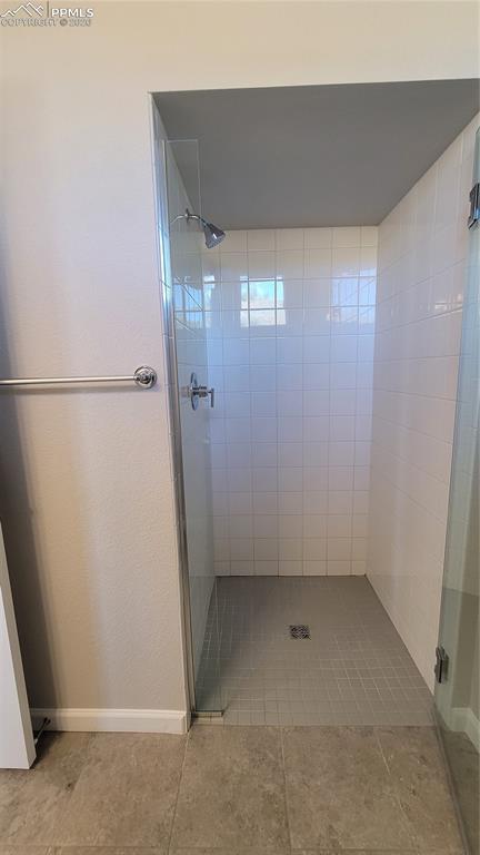 Image 6 of 28: 3/4 Bathroom with Quartz countertop and tile surround!
