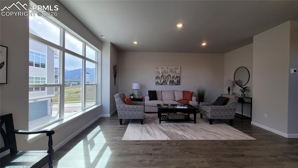 Image 9 of 28: Living room with LVP flooring, abundance of natural light, LED lighting, an