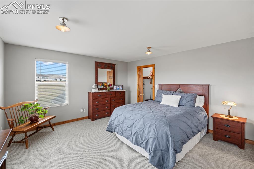 Image 20 of 25: Bedroom with light carpet and baseboards