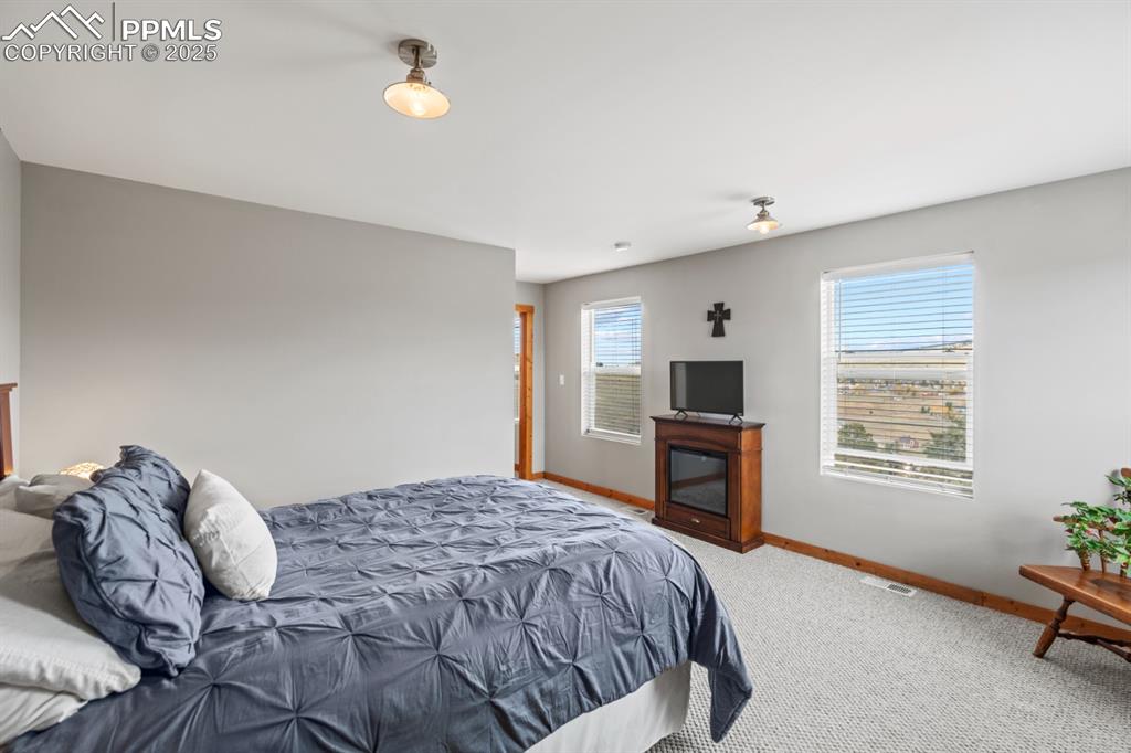 Image 21 of 25: Bedroom featuring baseboards and carpet