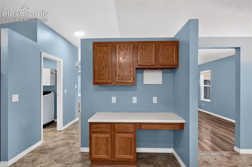 Image 9 of 27: Desk area off dining room
