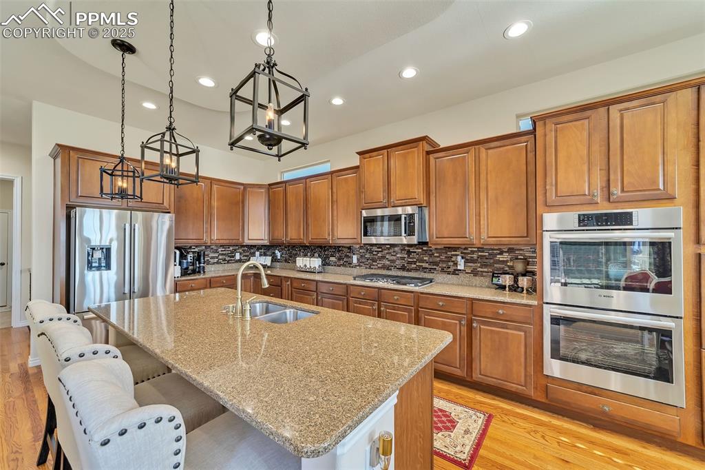 Image 8 of 49: Gourmet kitchen with double ovens, gas cooktop.