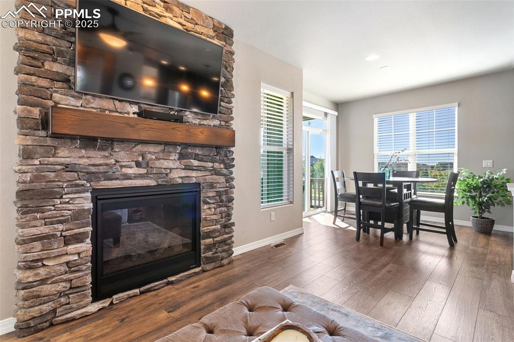 Image 17 of 50: Living room featuring hardwood / wood-style flooring and a fireplace