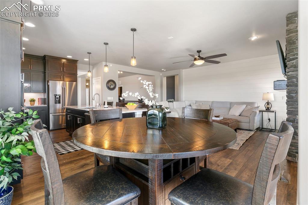Image 25 of 50: Dining room with dark wood-style flooring, ceiling fan, and recessed lighti