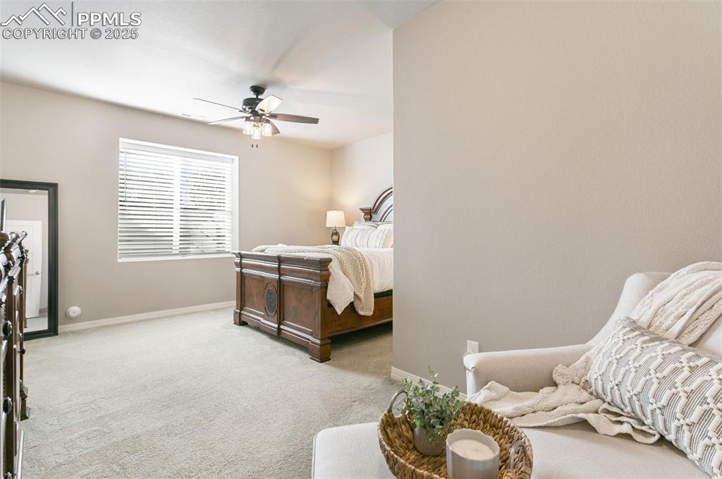 Image 27 of 50: Bedroom featuring light colored carpet and ceiling fan