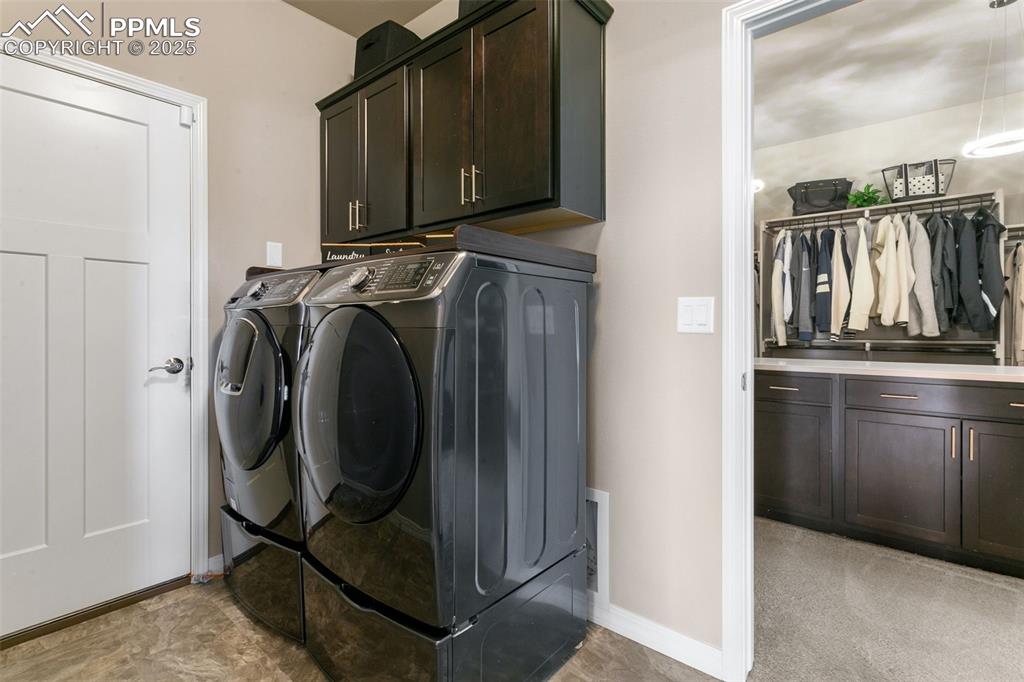 Image 37 of 50: Laundry room featuring cabinet space and separate washer and dryer