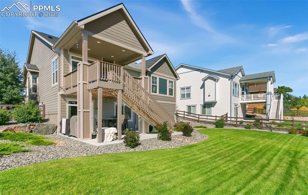 Image 50 of 50: Rear view of property with stairs, a patio, and a wooden deck