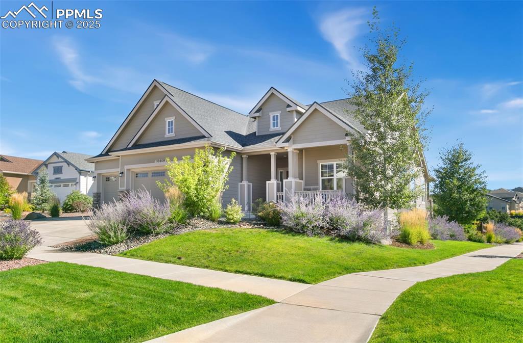 Image 6 of 50: Craftsman house with a front yard, a porch, and roof with shingles