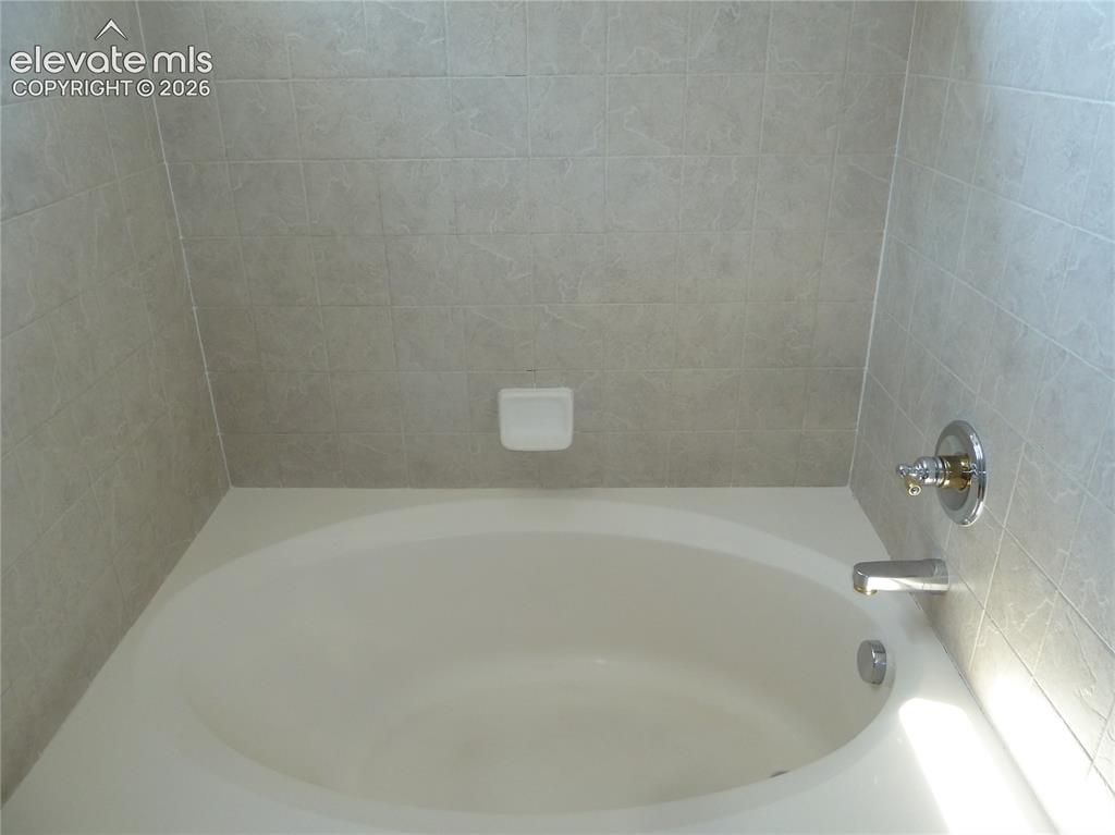 Image 18 of 18: Primary bathroom Garden tub.