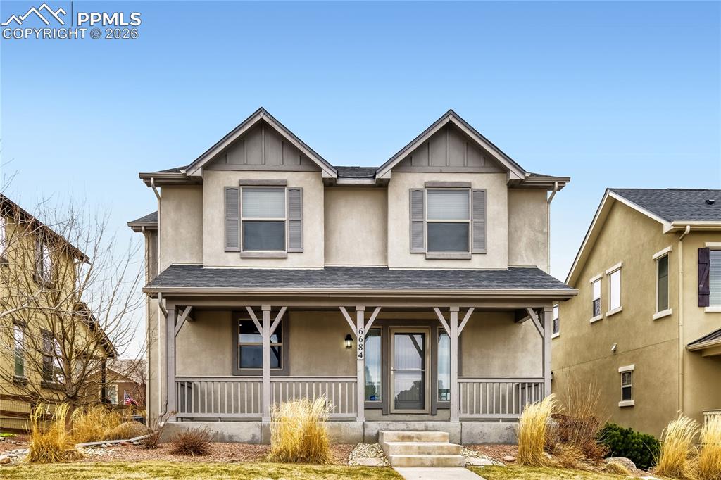 Image 1 of 34: View of front of house with stucco and covered porch