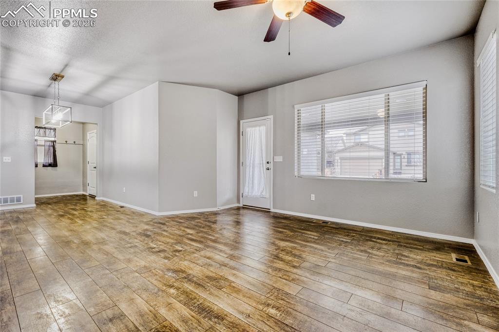Image 12 of 34: Living room featuring LVP floors, and ceiling fan