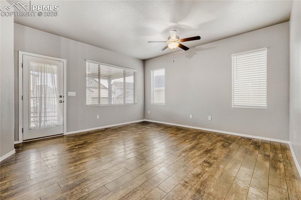 Image 13 of 34: LVP flooring, ceiling fan, and walk-out