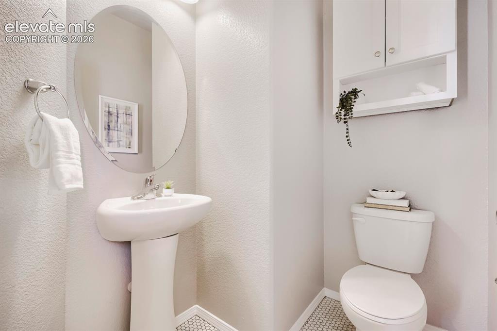 Image 14 of 35: Pedestal sink with an oval mirror and chrome faucet