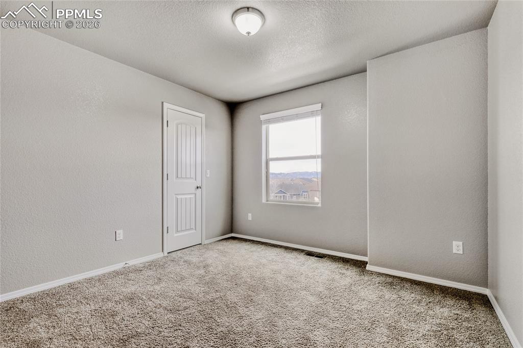 Image 16 of 34: Carpeted bedroom with closet and mountain View